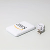 A white powerbank with a logo and a small USB cable beside it.