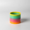 A drink bottle in vibrant rainbow colours, featuring shades of yellow, green, blue, and pink, with a sleek design.