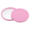 A pink circular makeup mirror with a smooth finish, featuring two sides—one reflective and one plain.