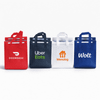 A collection of insulated reusable bags in red, navy, white, and blue, each featuring a logo.