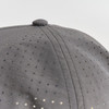 A grey cap with a perforated design, featuring small holes across the fabric. It has a rounded top button.