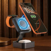 A black 3-in-1 wireless charging station features a magnetic holder for a smartphone, and holders for an Apple Watch and AirPods.