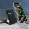 A black foldable wireless charger with a phone displaying charging status, featuring a logo on the charger.