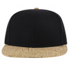 A snapback cap featuring a black top and a textured beige cork peak, with a logo on the front.