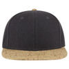 A cap with a flat brim featuring a dark fabric upper and a light cork-patterned peak, complete with a logo.
