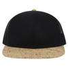 A black and cork 6 panel mid profile trucker cap featuring a rounded peak and mesh sides.