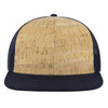 A six-panel mid-profile trucker cap featuring a cork-patterned front and a navy mesh back.