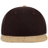 A five-panel cap featuring a dark brown fabric with a cork-patterned brim. It has a logo on the front.