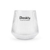 A clear glass tumbler with ribbed texture and a logo at the front.