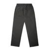 A pair of faded cuffless track pants in dark grey, featuring an elastic waistband and a minimal design.