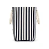 A striped tote bag in navy and white with two carry handles and a simple branding tag.
