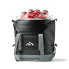 A black foldable cooler filled with ice and cans of Coca-Cola, featuring grey straps and a logo on the front.