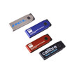 A group of four mini flash drives in silver, blue, red, and black colours, each featuring a logo or branding.