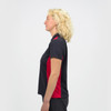 A women's polo shirt in black with red accents, featuring a collar and a side view of the model.