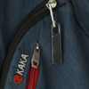 A silver Focus Flash Drive attached to a dark blue fabric with a red zipper and a logo on the material.