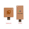 A small eco-friendly flash drive in a brown cardboard casing, featuring logos on each side.
