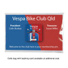 A 25mm aluminium badge featuring a scooter design, presented in a red and blue backing card with a logo.