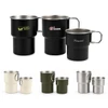 A collection of stainless steel camping mugs in black, green, white, and silver, featuring handles and various logos.