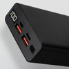 A black power bank with two USB ports, one USB-C port, and a digital display showing battery percentage.