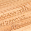 A close-up view of a bamboo surface engraved with text. The bamboo has a natural light brown colour.