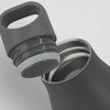 A drink bottle in a dark green colour with a silver interior and a removable lid featuring a handle.