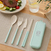 A mint green utensil set featuring a spoon, fork, knife, chopsticks, and a matching case on a table setting.