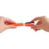 A pair of multifunctional scissors in orange, being held by two hands, showcasing a compact design.