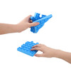 A blue Puzzle Shape Pop It fidget toy being held in one hand, with another hand touching a flat pop bubble base.