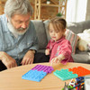 A colourful set of Puzzle Shape Pop It Fidget Toys in purple, blue, and green laid out on a table.
