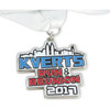 A custom medal featuring a skyline design in blue, red, and silver, attached to a white ribbon.
