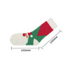 A pair of coral fleece socks featuring a festive design in green, red, and white colours, with a logo.
