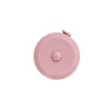 A pink round tape measure with a button on top, featuring a logo.