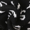 Acrylic fibres scarf featuring a black and white design, showcasing a textured knit pattern.