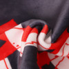 A close-up of a soft velvet scarf featuring red and black patterns, with a smooth, folded texture.