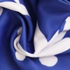 A close-up of a blue and white scarf with a patterned design, featuring a soft, textured fabric.