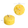 Round cheese shape candle in vibrant yellow, featuring holes on the surface, measuring 64mm in diameter and 34mm in height.