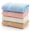 A stack of bamboo fiber towels in blue, pink, cream, and beige, neatly folded with a textured design.