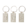 A trio of silver custom-shaped die struck keyrings with various logos and designs.