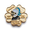 A gold embossed soft enamel pin featuring a stylised profile, set in a flower shape with inscriptions.