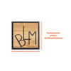 A custom-shaped bamboo lapel pin in a square design featuring a black outline and engraved letter design.