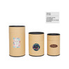 Large kraft paper cylinders with black lids, featuring decorative stickers in various designs and sizes.