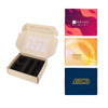 A subscription box packaging in beige with black inserts, accompanied by three colourful printed cards.