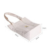 A cream-coloured heavy-duty tote bag with a square base and straps, featuring a logo on the front.