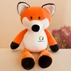 An orange and white fox plush toy with black details and a branding logo on its chest.