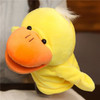 A plush duck hand puppet in bright yellow with an orange beak and black eyes, featuring a fluffy tuft on top.