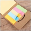 A mini sticky notes and flag set in various pastel colours, including yellow, pink, green, and blue, with a cardboard holder.