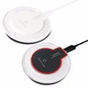 A white and a black wireless charger, featuring a circular design and a visible logo.