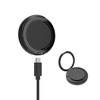 A black magnetic wireless charge stand with a USB cable, compact and circular in shape. Contains a logo.