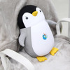 A penguin-shaped plush travel pillow in black, white, and yellow, featuring a small logo on its belly.