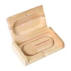 A wooden magnetic case in a light bamboo finish, featuring an inside compartment and a logo.